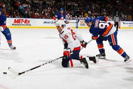 UNIONDALE, NY - FEBRUARY 26:  Boyd Gordon #15 of the Washington Capitals reaches for the puck as John Tavares #91 of the New York Islanders sneaks up from behind on February 26, 2011 at Nassau Coliseum in Uniondale, New York.  <br /><br /><span class="help">(Photo by Mike Stobe/NHLI via Getty Images)</span>