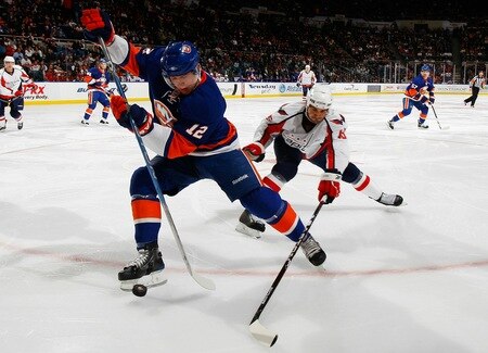 UNIONDALE, NY - FEBRUARY 26:  Josh Bailey #12 of the New York Islanders finds himself in an awkward position as Boyd Gordon #15 of the Washington Capitals reaches for the puck  on February 26, 2011 at Nassau Coliseum in Uniondale, New York.  <br /><br /><span class="help">(Photo by Mike Stobe/NHLI via Getty Images)</span>