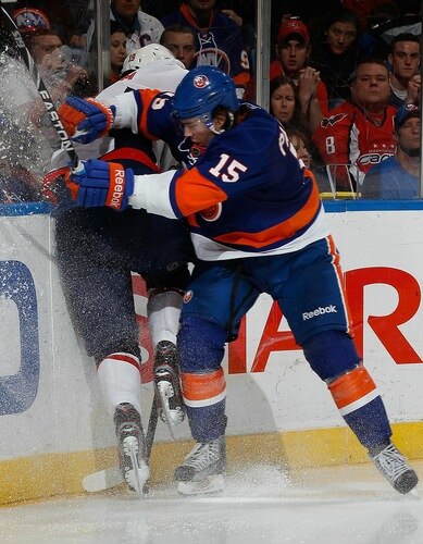 UNIONDALE, NY - FEBRUARY 26:  Nicklas Backstrom #19 of the Washington Capitals gets checked hard into the boards by PA Parenteau #15 of the New York Islanders on February 26, 2011 at Nassau Coliseum in Uniondale, New York.  <br /><br /><span class="help">(Photo by Mike Stobe/NHLI via Getty Images)</span>