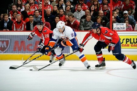 WASHINGTON, DC - MARCH 01:  Alexander Semin #28 and John Erskine #4 of the Washington Capitals battle for the puck against Kyle Okposo #21 of the New York Islanders at the Verizon Center on March 1, 2011 in Washington, DC.  <br /><br /><span class="help">(Photo by Greg Fiume/Getty Images)</span>