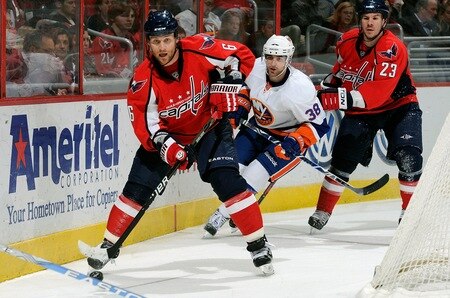 WASHINGTON, DC - MARCH 01:  Dennis Wideman #6 of the Washington Capitals brings the puck around the net against Jack Hillen #38 of the New York Islanders at the Verizon Center on March 1, 2011 in Washington, DC.  <br /><br /><span class="help">(Photo by Greg Fiume/Getty Images)</span>