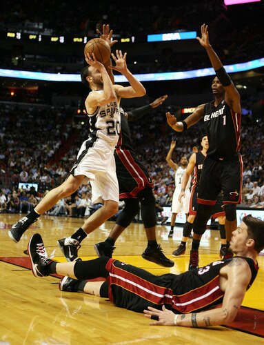MIAMI - MARCH 14:  Forward Manu Ginobili #20 comimits an offensive foul against Mike Miller #13 of the Miami Heat at American Airlines Arena on March 14, 2011 in Miami, Florida. <br /><br /><span class="help">(Photo by Marc Serota/Getty Images)</span>
