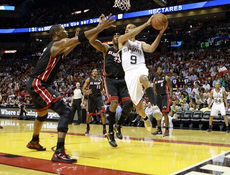 MIAMI - MARCH 14:  Guard Tony Parker #9 of the San Antonio Spurs drives on Dwyane Wade #3 of the Miami Heat at American Airlines Arena on March 14, 2011 in Miami, Florida. <br /><br /><span class="help">(Photo by Marc Serota/Getty Images)</span>