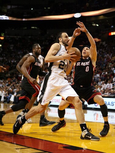 MIAMI - MARCH 14:  Forward Manu Ginobili #20 of the San Antonio Spurs drives against Mike Bibby #0 of the Miami Heat at American Airlines Arena on March 14, 2011 in Miami, Florida. <br /><br /><span class="help">(Photo by Marc Serota/Getty Images)</span>