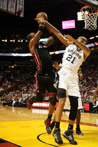 MIAMI - MARCH 14:  Forward Chris Bosh #1 of the Miami Heat is fouled by Center Tim Duncan #21 of the San Antonio Spurs at American Airlines Arena on March 14, 2011 in Miami, Florida. <br /><br /><span class="help">(Photo by Marc Serota/Getty Images)</span>