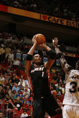 MIAMI - MARCH 14: Chris Bosh #1 of the Miami Heat shoots over Antonio McDyess  #34 of the San Antonio Spurs on March 14, 2011 at American Airlines Arena in Miami, Florida. <br /><br /><span class="help">(Photo by Issac Baldizon/NBAE via Getty Images)</span>