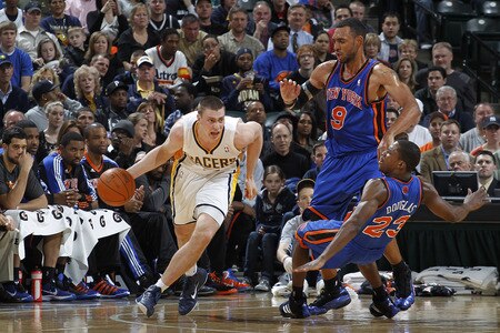 INDIANAPOLIS, IN - MARCH 15: Tyler Hansbrough #50 of the Indiana Pacers dribbles around Jared Jeffries #9 and Toney Douglas #23 of the New York Knicks on March 15, 2011 at Conseco Fieldhouse in Indianapolis, Indiana. The Pacers defeated the Knicks 119-117. <br /><br /><span class="help">(Photo by Joe Robbins/NBAE via Getty Images)</span>