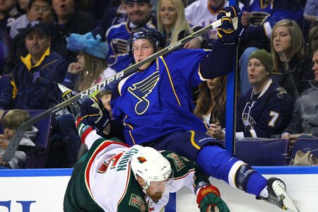 ST. LOUIS, MO - MARCH 29: David Backes #42 of the St. Louis Blues is chacked into the boards by Greg Zanon #5 of the Minnesota Wild at the Scottrade Center on March 29, 2011 in St. Louis, Missouri.  <br /><br /><span class="help">(Photo by Dilip Vishwanat/Getty Images)</span>