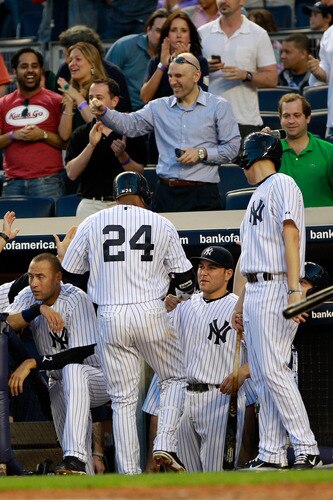 NEW YORK, NY - APRIL 26:  Robinson Cano #24 of the New York Yankees is congratulated by his teammates after hitting a homer in the second inning against the Chicago White Sox at Yankee Stadium on April 26, 2011 in the Bronx borough of New York City.  <br /><br /><span class="help">(Photo by Chris Trotman/Getty Images)</span>