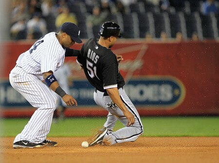NEW YORK, NY - APRIL 26:  Robinson Cano #24 of the New York Yankees drops the ball as Alex Rios #51 is safe at second base in the fifth inning against the Chicago White Sox at Yankee Stadium on April 26, 2011 in the Bronx borough of New York City.  <br /><br /><span class="help">(Photo by Chris Trotman/Getty Images)</span>