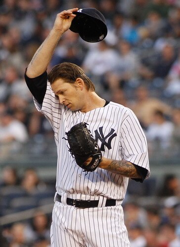 NEW YORK - MAY 21:  A.J. Burnett #34 of the New York Yankees wipes his forehead after giving up a run in the first inning against the New York Mets on May 21, 2011 at Yankee Stadium in the Bronx borough of New York City.  <br /><br /><span class="help">(Photo by Mike Stobe/Getty Images)</span>