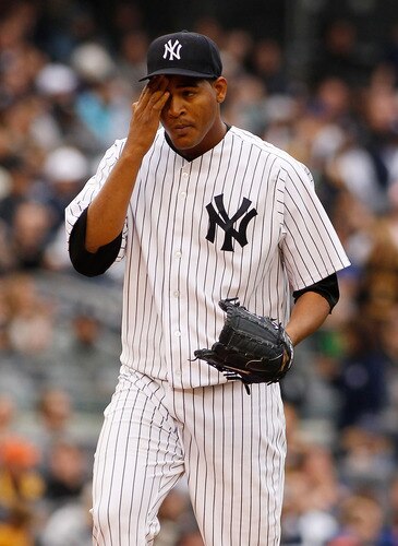 NEW YORK - MAY 22:  Ivan Nova #47 of the New York Yankees wipes his forehead during the game against the New York Mets on May 22, 2011 at Yankee Stadium in the Bronx borough of New York City.  <br /><br /><span class="help">(Photo by Mike Stobe/Getty Images)</span>