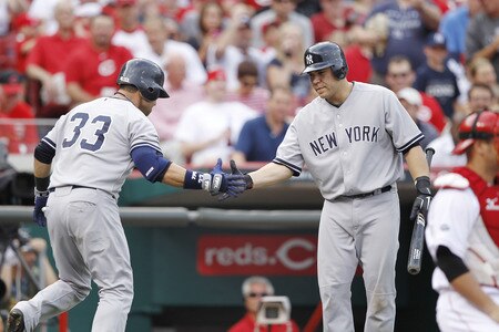 CINCINNATI, OH - JUNE 22: Nick Swisher #33 of the New York Yankees is greeted by teammate Russell Martin #55 after hitting a home run in the second inning during the second game of a doubleheader against the Cincinnati Reds at Great American Ball Park on June 22, 2011 in Cincinnati, Ohio. <br /><br /><span class="help">(Photo by Joe Robbins/Getty Images)</span>