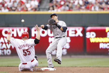 CINCINNATI, OH - JUNE 22: Ramiro Pena #19 of the New York Yankees throws to first base to turn a double play over Ramon Hernandez #55 of the Cincinnati Reds during the second game of a doubleheader at Great American Ball Park on June 22, 2011 in Cincinnati, Ohio. <br /><br /><span class="help">(Photo by Joe Robbins/Getty Images)</span>