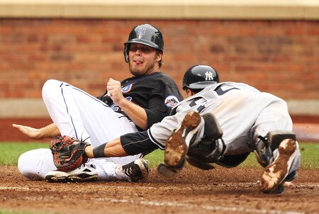 NEW YORK, NY - JULY 03:  Lucas Duda #21 of the New York Mets is tagged out by Russell Martin #55 of the New York Yankees in the ninth inning of their game on July 3, 2011 at Citi Field in the Flushing neighborhood of the Queens borough of New York City.  <br /><br /><span class="help">(Photo by Al Bello/Getty Images)</span>