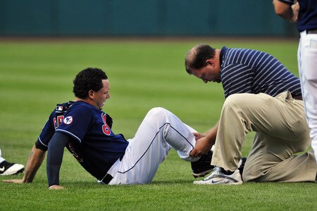 CLEVELAND, OH - JULY 5: Asdrubal Cabrera #13 of the Cleveland Indians is looked at by trainer Rick Jameyson during the third inning against the New York Yankees at Progressive Field on July 5, 2011 in Cleveland, Ohio. <br /><br /><span class="help">(Photo by Jason Miller/Getty Images)</span>