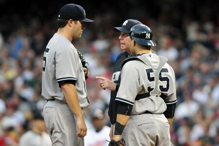 CLEVELAND, OH - JULY 6: Starting pitcher Phil Hughes #65 talks with pitching coach Larry Rothschild #58 and catcher Russell Martin #55 of the New York Yankees during the fifth inning against the Cleveland Indians at Progressive Field on July 6, 2011 in Cleveland, Ohio. <br /><br /><span class="help">(Photo by Jason Miller/Getty Images)</span>