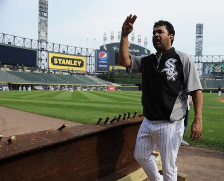 CHICAGO, IL - AUGUST 01: Ozzie Guillen #13 manager of the Chicago White Sox looks at an 8-foot steel I-beam from the World Trade Center wreckage on display during the Chicago White Sox and New York Yankees game on August 1, 2011 at U.S. Cellular Field in Chicago, Illinois. The beam will have permanent home in Darien, Illinois.  <br /><br /><span class="help">(Photo by David Banks/Getty Images)</span>