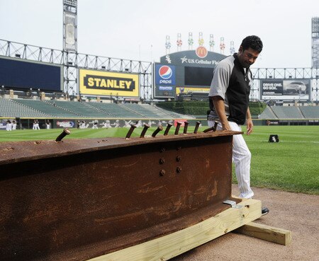 CHICAGO, IL - AUGUST 01: Ozzie Guillen #13 manager of the Chicago White Sox looks at an 8-foot steel I-beam from the World Trade Center wreckage on display during the Chicago White Sox and New York Yankees game on August 1, 2011 at U.S. Cellular Field in Chicago, Illinois. The beam will have permanent home in Darien, Illinois.  <br /><br /><span class="help">(Photo by David Banks/Getty Images)</span>