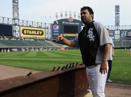 CHICAGO, IL - AUGUST 01: Ozzie Guillen #13 manager of the Chicago White Sox looks at an 8-foot steel I-beam from the World Trade Center wreckage on display during the Chicago White Sox and New York Yankees game on August 1, 2011 at U.S. Cellular Field in Chicago, Illinois. The beam will have permanent home in Darien, Illinois.  <br /><br /><span class="help">(Photo by David Banks/Getty Images)</span>