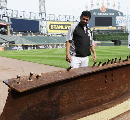 CHICAGO, IL - AUGUST 01: Ozzie Guillen #13 manager of the Chicago White Sox looks at an 8-foot steel I-beam from the World Trade Center wreckage on display during the Chicago White Sox and New York Yankees game on August 1, 2011 at U.S. Cellular Field in Chicago, Illinois. The beam will have permanent home in Darien, Illinois.  <br /><br /><span class="help">(Photo by David Banks/Getty Images)</span>