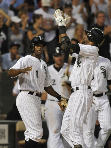 CHICAGO, IL - AUGUST 01:  Alexei Ramirez #10 of the Chicago White Sox points skyward and is greeted by Juan Pierre #1 after hitting a two-run homer in the fourth inning against the New York Yankees on August 1, 2011 at U.S. Cellular Field in Chicago, Illinois.  <br /><br /><span class="help">(Photo by David Banks/Getty Images)</span>