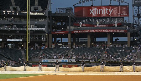 CHICAGO, IL - AUGUST 02: Members of the grounds crew place a tarp over infield signaling a delay in the start of a game between the Chicago White Sox and the New York Yankees at U.S. Cellular Field on August 2, 2011 in Chicago, Illinois. <br /><br /><span class="help">(Photo by Jonathan Daniel/Getty Images)</span>