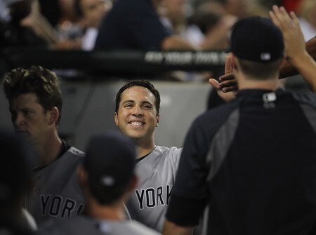 CHICAGO, IL - AUGUST 03:  Mark Teixiera #25 of the New York Yankees smiles as he is greeted by teammates in the dugout after hitting a run-scoring triple and then scoring in the 3rd inning against the Chicago White Sox at U.S. Cellular Field on August 3, 2011 in Chicago, Illinois.  <br /><br /><span class="help">(Photo by Jonathan Daniel/Getty Images)</span>