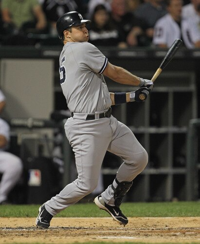 CHICAGO, IL - AUGUST 03:  Mark Teixiera #25 of the New York Yankees hits a run-scoring triple in the 3rd inning against the Chicago White Sox at U.S. Cellular Field on August 3, 2011 in Chicago, Illinois.  <br /><br /><span class="help">(Photo by Jonathan Daniel/Getty Images)</span>
