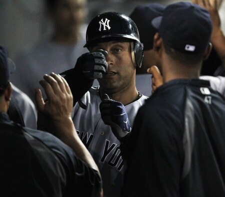 CHICAGO, IL - AUGUST 03: Derek Jeter #2 of the New York Yankees is congratulated by teammates in the dugout after scoring in the 3rd inning against the Chicago White Sox at U.S. Cellular Field on August 3, 2011 in Chicago, Illinois. <br /><br /><span class="help">(Photo by Jonathan Daniel/Getty Images)</span>