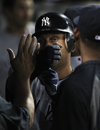 CHICAGO, IL - AUGUST 03:  Derek Jeter #2 of the New York Yankees is congratulated by teammates in the dugout after scoring in the 3rd inning against the Chicago White Sox at U.S. Cellular Field on August 3, 2011 in Chicago, Illinois.  <br /><br /><span class="help">(Photo by Jonathan Daniel/Getty Images)</span>