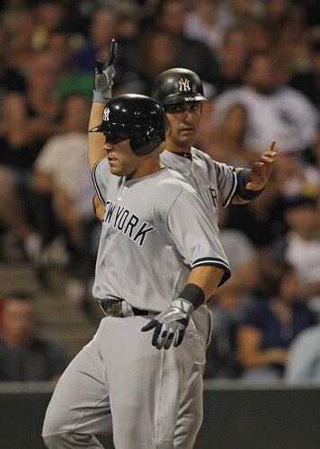 CHICAGO, IL - AUGUST 03: Russell Martin #55 of the New York Yankees (L) is greeted by teammate Jorge Posada #20 after they both scored in the 3rd inning against the Chicago White Sox at U.S. Cellular Field on August 3, 2011 in Chicago, Illinois. <br /><br /><span class="help">(Photo by Jonathan Daniel/Getty Images)</span>