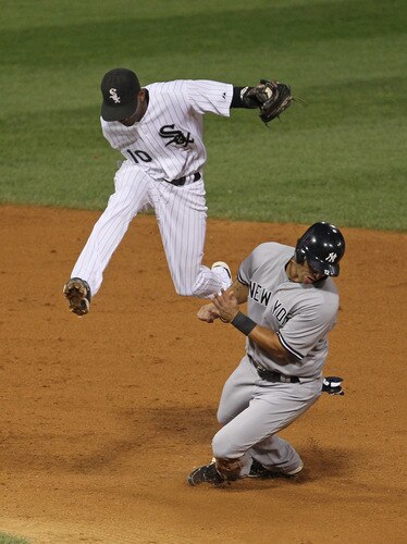 CHICAGO, IL - AUGUST 03: Alexei Ramirez #10 of the Chicago White Sox hops over Eric Chavez #12 of the New York Yankees after a force out to end the 7th inning at U.S. Cellular Field on August 3, 2011 in Chicago, Illinois. <br /><br /><span class="help">(Photo by Jonathan Daniel/Getty Images)</span>
