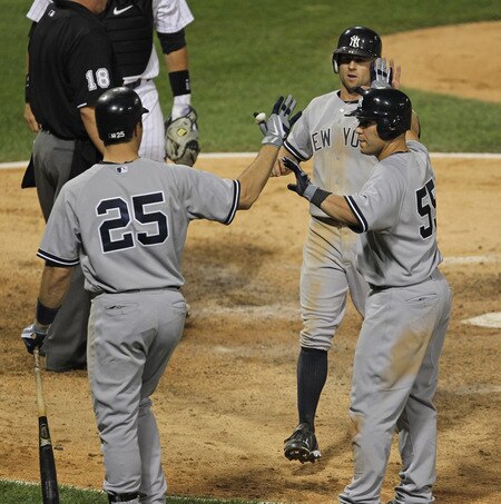 CHICAGO, IL - AUGUST 03: Mark Teixiera #25 of the New York Yankees greets teammates Russell Martin #55 and Brett Gardner #11 as they score runs in the 7th inning against the Chicago White Sox at U.S. Cellular Field on August 3, 2011 in Chicago, Illinois. <br /><br /><span class="help">(Photo by Jonathan Daniel/Getty Images)</span>