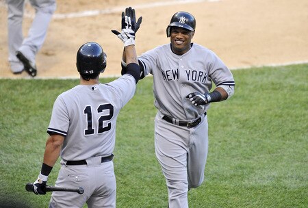 CHICAGO, IL - AUGUST 04:  Eric Chavez #12 of the New York Yankees high fives his teammate Robinson Cano #24 after Cano hit a solo home run during the second inning against the Chicago White Sox at U.S. Cellular Field on August 4, 2011 in Chicago, Illinois.  <br /><br /><span class="help">(Photo by Brian Kersey/Getty Images)</span>
