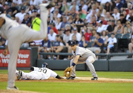 CHICAGO, IL - AUGUST 04:  Alejandro De Aza #30 (C) of the Chicago White Sox dives back to first base as first baseman Mark Teixeira #25 (R) of the New York Yankees catches a pick-off throw from pitcher Ivan Nova during the third inning at U.S. Cellular Field on August 4, 2011 in Chicago, Illinois. De Aza was safe on the play.  <br /><br /><span class="help">(Photo by Brian Kersey/Getty Images)</span>