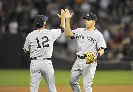 CHICAGO, IL - AUGUST 04:  Eric Chavez #12 of the New York Yankees and teammate Mark Teixeira celebrate their 7-2 win over the Chicago White Sox at U.S. Cellular Field on August 4, 2011 in Chicago, Illinois.  <br /><br /><span class="help">(Photo by Brian Kersey/Getty Images)</span>