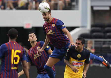 ARLINGTON, TX - AUGUST 06: Gerard Pique #3 of FC Barcelona heads the ball against Daniel Montenegro #10 of Club America at Cowboys Stadium on August 6, 2011 in Arlington, Texas. <br /><br /><span class="help">(Photo by Ronald Martinez/Getty Images)</span>
