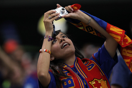 ARLINGTON, TX - AUGUST 06: A fan of FC Barcelona takes pictures during a match against Club America at Cowboys Stadium on August 6, 2011 in Arlington, Texas. <br /><br /><span class="help">(Photo by Ronald Martinez/Getty Images)</span>