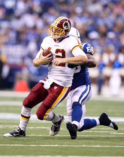 INDIANAPOLIS, IN - AUGUST 19:  John Beck #12 of the Washington Redskins is tackled by Gary Brackett #58 of the Indianapolis Colts during the game at Lucas Oil Stadium on August 19, 2011 in Indianapolis, Indiana.  <br /><br /><span class="help">(Photo by Andy Lyons/Getty Images)</span>