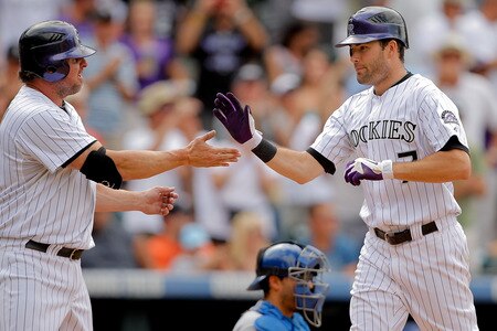 DENVER, CO - AUGUST 21:  Seth Smith #7 of the Colorado Rockies is greeted at home plate by Jason Giambi #23 after hitting a two run go-ahead home run during the seventh inning against the Los Angeles Dodgers at Coors Field on August 21, 2011 in Denver, Colorado.  The Rockies defeated the Dodgers 5-3. <br /><br /><span class="help">(Photo by Justin Edmonds/Getty Images)</span>