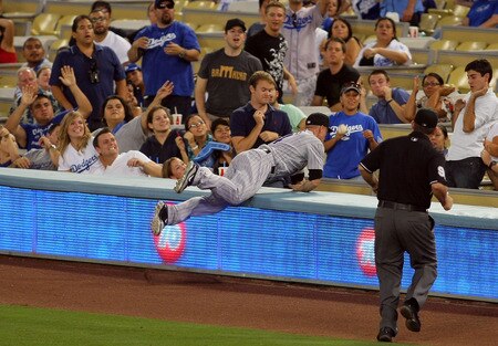 LOS ANGELES, CA - AUGUST 26:  Outfielder Carlos Gonzalez #5 of the Colorado Rockies tries to catch a foul ball in the stands in the first inning during the MLB game against the Los Angeles Dodgers at Dodger Stadium on August 26, 2011 in Los Angeles, California.  <br /><br /><span class="help">(Photo by Victor Decolongon/Getty Images)</span>
