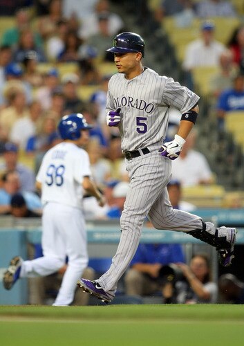 LOS ANGELES, CA - AUGUST 26:  Carlos Gonzalez #5 of the Colorado Rockies rounds third base after hitting a first inning home run during the MLB game against the Los Angeles Dodgers at Dodger Stadium on August 26, 2011 in Los Angeles, California.  <br /><br /><span class="help">(Photo by Victor Decolongon/Getty Images)</span>