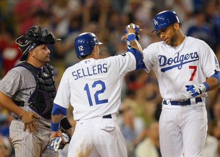 LOS ANGELES, CA - AUGUST 26:  James Loney #7 and Justin Sellers #12 of the Los Angeles Dodgers celebrate at home plate after Loney hit a two-run home run in the seventh inning as catcher Eliezer Alfonzo #55 of the Colorado Rockies looks on during the MLB game at Dodger Stadium on August 26, 2011 in Los Angeles, California.  <br /><br /><span class="help">(Photo by Victor Decolongon/Getty Images)</span>