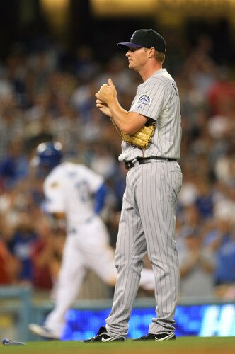 LOS ANGELES, CA - AUGUST 26:  Pitcher Matt Reynolds #51 of the Colorado Rockies looks on as Matt Kemp #27 of the Los Angeles Dodgers rounds third base after hitting a solo home run in the seventh inning during the MLB game at Dodger Stadium on August 26, 2011 in Los Angeles, California. The Dodgers defeated the Rockies 6-1. <br /><br /><span class="help">(Photo by Victor Decolongon/Getty Images)</span>