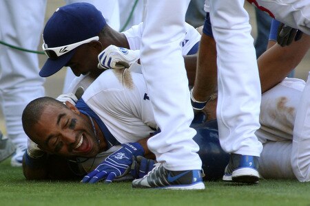 LOS ANGELES, CA - AUGUST 27:  Matt Kemp #27 of the Los Angeles Dodgers is mobbed by Eugenio Velez #3 and teammates at home plate as they celebrate his game-winning solo home run against the Colorado Rockies in the bottom of the 11th inning at Dodger Stadium on August 27, 2011 in Los Angeles, California.  The Dodgers won 7-6.  <br /><br /><span class="help">(Photo by Jeff Golden/Getty Images)</span>