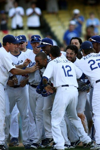 LOS ANGELES, CA - AUGUST 27:  Matt Kemp #27 of the Los Angeles Dodgers is mobbed by teammates at home plate as they celebrate his game-winning solo home run against the Colorado Rockies in the bottom of the 11th inning at Dodger Stadium on August 27, 2011 in Los Angeles, California.  The Dodgers won 7-6.  <br /><br /><span class="help">(Photo by Jeff Golden/Getty Images)</span>