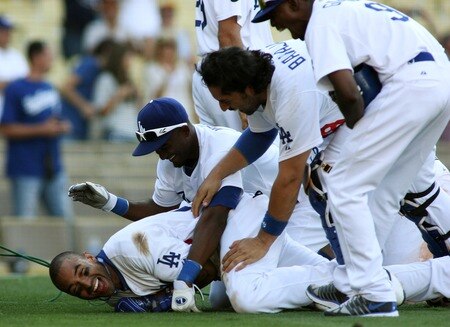 LOS ANGELES, CA - AUGUST 27:  Matt Kemp #27 of the Los Angeles Dodgers is mobbed by Eugenio Velez #3, Rod Barajas #28, Dee Gordon #9 and teammates as they celebrate his game-winning solo home run against the Colorado Rockies in the bottom of the 11th inning at Dodger Stadium on August 27, 2011 in Los Angeles, California.  The Dodgers won 7-6.  <br /><br /><span class="help">(Photo by Jeff Golden/Getty Images)</span>