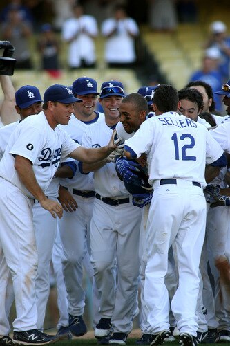LOS ANGELES, CA - AUGUST 27:  Matt Kemp #27 of the Los Angeles Dodgers is mobbed by teammates at home plate as they celebrate his game-winning solo home run against the Colorado Rockies in the bottom of the 11th inning at Dodger Stadium on August 27, 2011 in Los Angeles, California.  The Dodgers won 7-6.  <br /><br /><span class="help">(Photo by Jeff Golden/Getty Images)</span>