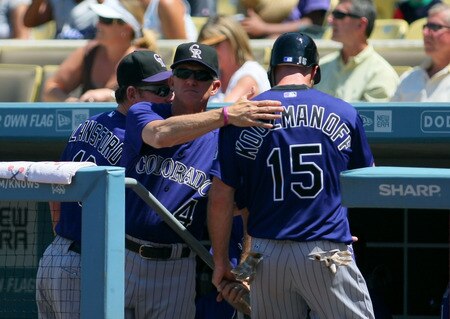 LOS ANGELES, CA - AUGUST 28:  Manager Jim Tracy #42 of the Colorado Rockies pats Kevin Kouzmanoff #15 on the back after Kouzmanoff scored in the first inning against the Los Angeles Dodgers during the MLB game at Dodger Stadium on August 28, 2011 in Los Angeles, California.  <br /><br /><span class="help">(Photo by Victor Decolongon/Getty Images)</span>